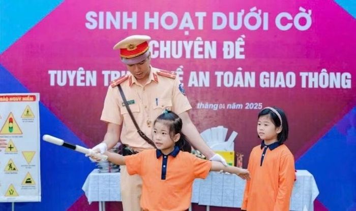 Cán bộ CSGT hướng dẫn học sinh kiến thức về an toàn giao thông.