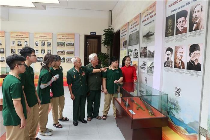 Cựu tù Côn Đảo Vũ Văn Kim kể chuyện những câu chuyện về nhà tù Côn Đảo cho học sinh. Ảnh: Danh Lam - TTXVN