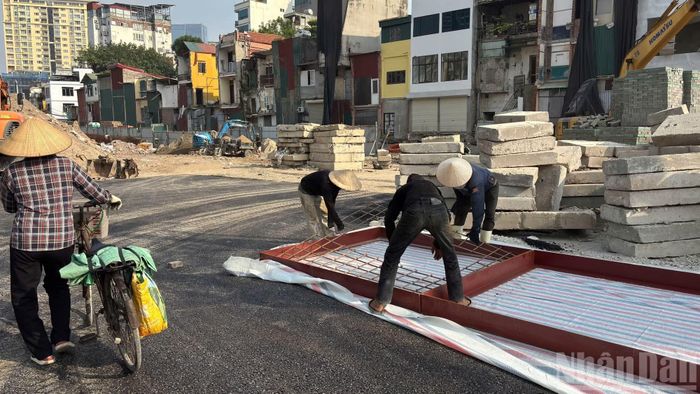 Công nhân đang khẩn trương thi công các hạng mục hạ tầng ngầm, lắp đặt hệ thống cống thoát nước, đồng thời rải đá base gia cố nền đường, chuẩn bị cho công tác thảm bê-tông nhựa.