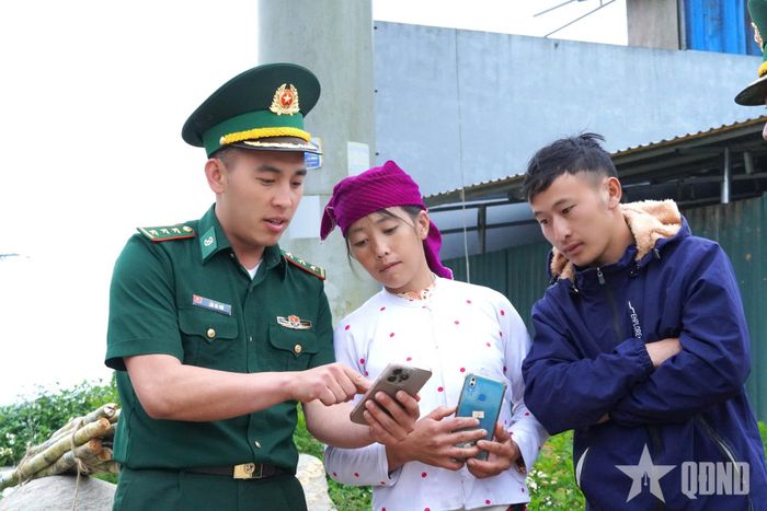 Cán bộ Đồn Biên phòng Cửa khẩu Săm Pun hướng dẫn người dân xã Sơn Vĩ (Tuyên Quang) sử dụng các nền tảng số.