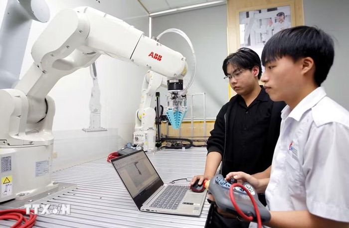 Sinh viên thực hành thử nghiệm các thuật toán điều khiển cánh tay robot tại phòng thí nghiệm Robotics, Trường Đại học Công nghiệp Thành phố Hồ Chí Minh. (Ảnh minh họa: Thanh Vũ/TTXVN)