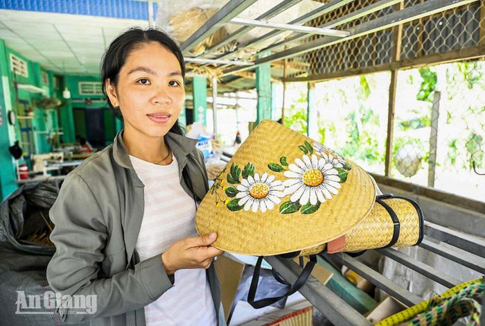 Ngoài làm sản phẩm truyền thống, chị Trần Thị Trang, ngụ xã Ba Chúc, còn sáng tạo vẻ hoa trên chiếc nón cỏ bàng, thu hút rất nhiều khách hàng tìm mua.