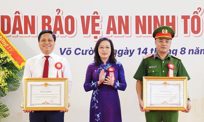  Đồng chí Nguyễn Thị Hương trao Bằng khen của Chủ tịch UBND tỉnh cho cán bộ, Nhân dân và Công an phường Võ Cường. 