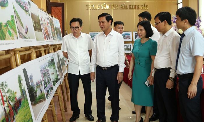  Phó Chủ tịch UBND tỉnh Lê Xuân Lợi cùng các đại biểu tham quan trưng bày ảnh về phòng tuyến sông Như Nguyệt trong khuôn khổ hội thảo.  