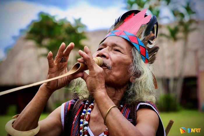Già làng Bhriu Pố, nghệ nhân Cơ Tu ở thôn Lăng trình diễn nghệ thuật giả tiếng chim thú. Ảnh: ALĂNG NGƯỚC