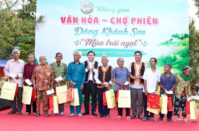 Đồng chí Lâm Đông và lãnh đạo xã Đông Khánh Sơn trao quà cho các hộ dân.