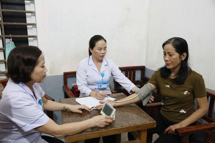 Cán bộ Trạm Y tế phường Hà Huy Tập (Hà Tĩnh) tranh thủ ban đêm, đến từng hộ gia đình khám sàng lọc cho người dân. Ảnh: Nhật Thắng.