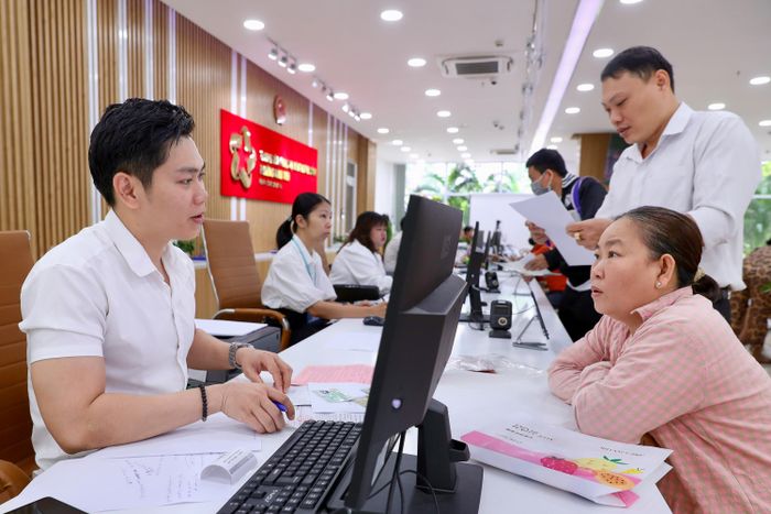 Công chức phường Bình Tiên (TPHCM) tiếp nhận, giải quyết thủ tục hành chính cho người dân (ẢNH: KHẢ HÂN)