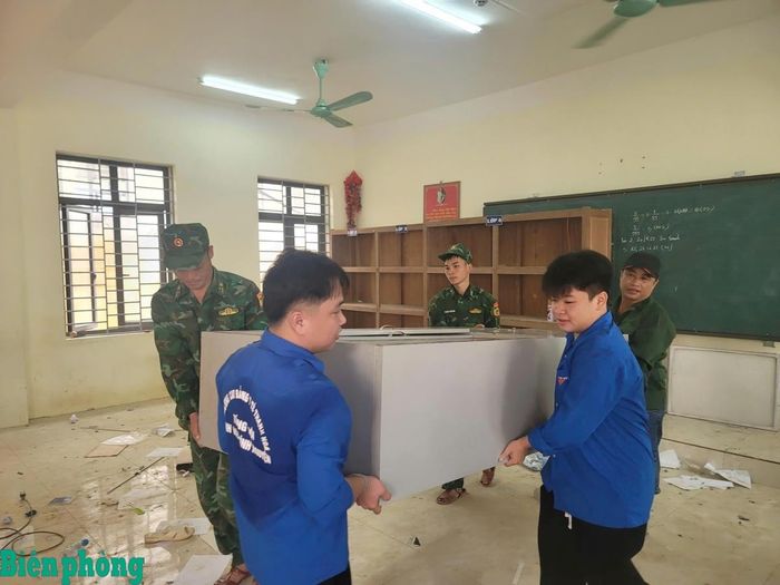 Cán bộ, chiến sĩ Đồn Biên phòng Yên Khương phối hợp với các lực lượng vận chuyển vật tư, thiết bị phục vụ xây dựng trường. Ảnh: Xuân Lâm