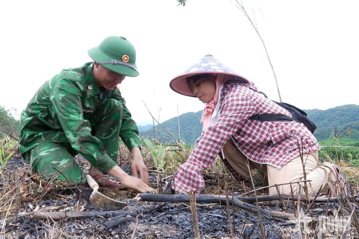Bộ đội hướng dẫn người dân kỹ thuật trồng cây.