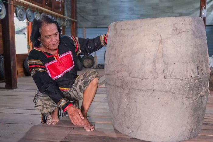  Nghệ nhân ưu tú Nay Phai giới thiệu chiếc trống cổ của người Jrai có tuổi đời trên 200 năm. Ảnh: M.Châu 