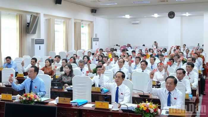 Các đại biểu Hội đồng nhân dân tỉnh Cà Mau biểu quyết thông qua các nghị quyết đặc thù cho trẻ em và học sinh Cà Mau tại kỳ họp vào chiều 17/8. (Ảnh: HỮU TÙNG)