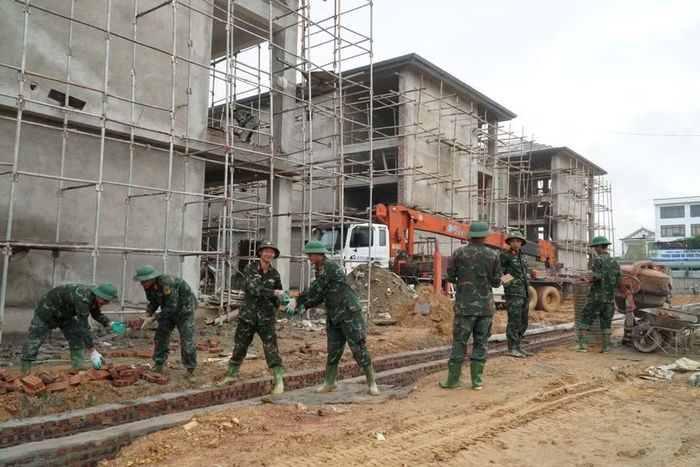 Cán bộ, chiến sĩ Trung đoàn 335 có mặt tại công trường xây dựng Trường phổ thông nội trú liên cấp Tiểu học và THCS Anh Sơn để hỗ trợ đơn vị thi công. Ảnh: Hồ Lài