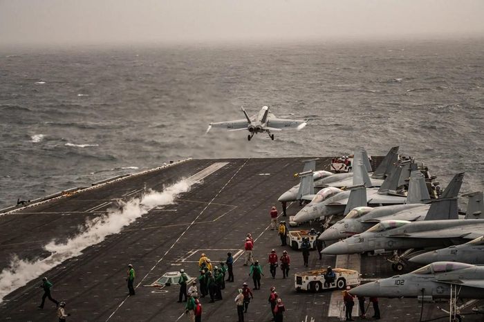 Các thủy thủ trên tàu sân bay USS Abraham Lincoln triển khai máy bay chiến đấu. Ảnh: NYT