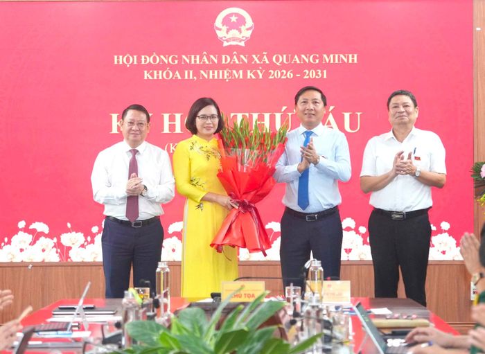 Các đồng chí lãnh đạo tặng hoa chúc mừng đồng chí Nguyễn Thị Ngọc Hà được bầu giữ chức Chủ tịch HĐND xã Quang Minh. Ảnh: Phạm Hùng