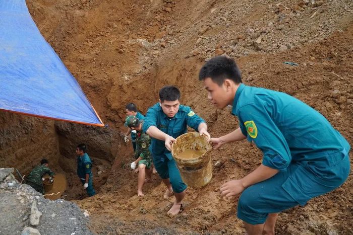 Các lực lượng chức năng mở rộng phạm vi tìm kiếm hài cốt các liệt sĩ còn lại trong khu mộ tập thể. (Ảnh: PV/Vietnam+)