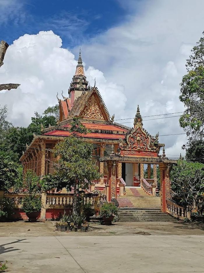 Chánh điện Chùa Som Rong với hệ thống mái nhiều tầng và những họa tiết đặc trưng của kiến trúc Phật giáo Nam tông Khmer. Ảnh: Tường Quang↵