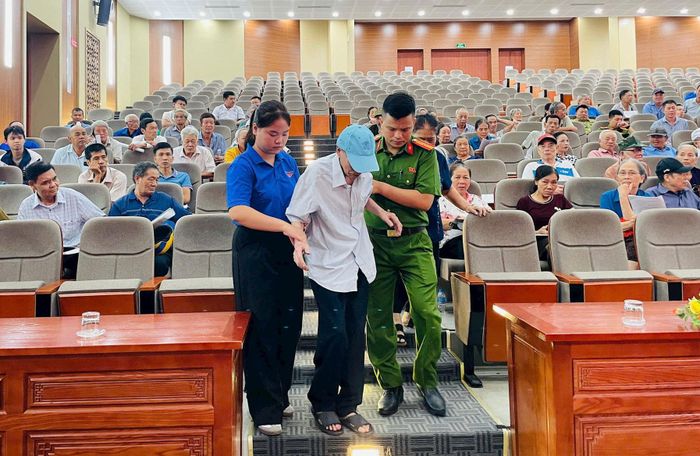 Cán bộ công an và đoàn viên thanh niên xã Đông Anh hỗ trợ thân nhân liệt sĩ hoàn thành thủ tục lấy mẫu ADN. Ảnh Mai Khôi