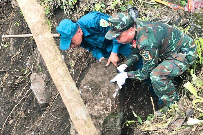 Dân quân cùng bộ đội di chuyển tảng đá để kiểm tra khu vực bên dưới. Ảnh: Tuấn Anh