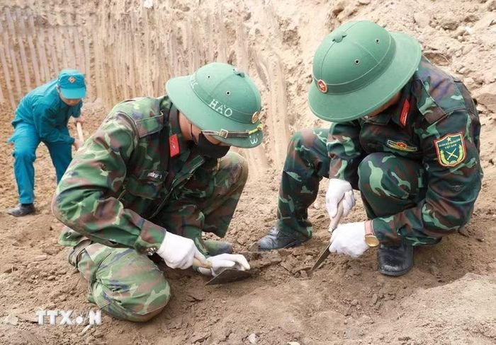 Đội Quy tập hài cốt liệt sỹ Bộ Chỉ huy Quân sự tỉnh Khánh Hòa cẩn trọng đào từng lớp đất để tìm kiếm hài cốt và di vật. (Ảnh: Xuân Triệu/TTXVN)