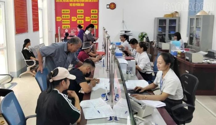 Cán bộ Trung tâm Phục vụ hành chính công xã Bảo Ái hướng dẫn người dân thực hiện thủ tục hành chính. (Ảnh: Hồng Duyên)