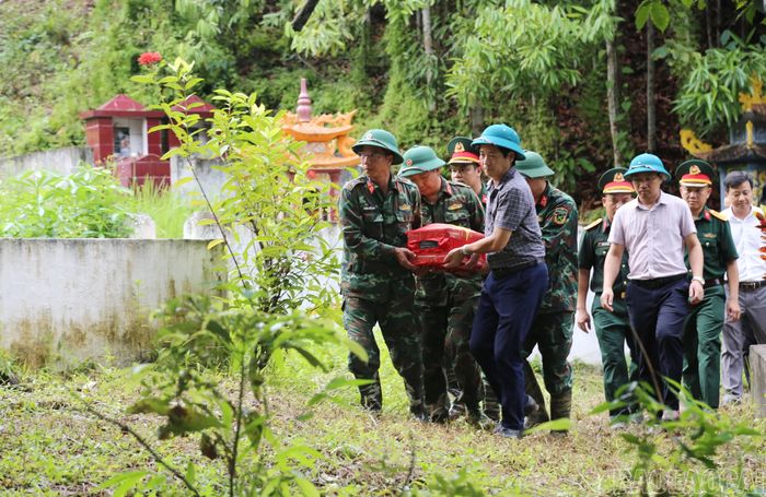  Cán bộ, chiến sĩ và các lực lượng tham gia đưa hài cốt liệt sĩ Bùi Văn Tự rời khu vực khai quật. 