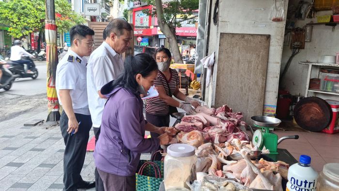 Đoàn công tác kiểm tra vệ sinh an toàn thực phẩm của các hộ kinh doanh trên các tuyến phố, ngõ thuộc địa bàn phường Ô Chợ Dừa. Ảnh: Ánh Dương