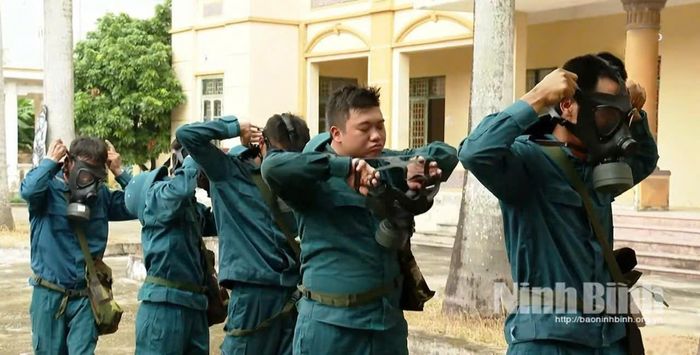 Lực lượng dân quân phòng hóa thực hành kỹ năng mang, đeo mặt nạ phòng độc sẵn sàng cho các nhiệm vụ phòng thủ dân sự.