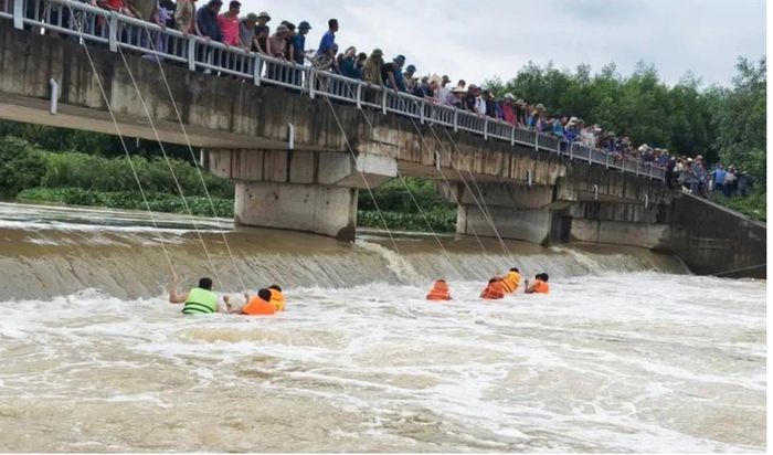 Các cán bộ chiến Công an xã, Ban chỉ huy quân sự xã Giai Lạc, Nghệ An kéo dây thừng tìm kiếm nạn nhân - Ảnh: KHANG HÒA/ Báo ĐT Tuổi trẻ.