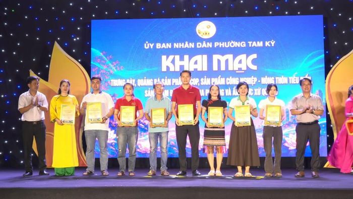 Ban Tổ chức trao giấy chứng nhận cho các cơ quan, đơn vị, doanh nghiệp tham gia quảng bá sản phẩm. Ảnh: Nguyễn Tín.