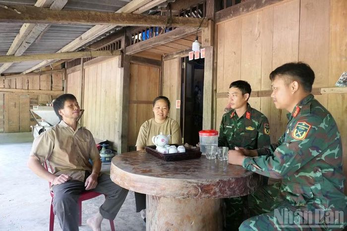 Cán bộ, chiến sĩ Đội Tìm kiếm, quy tập hài cốt liệt sĩ tuyên truyền, vận động ông Hầu Sào Chung di chuyển nhà để công tác tìm kiếm tiếp tục được thực hiện.