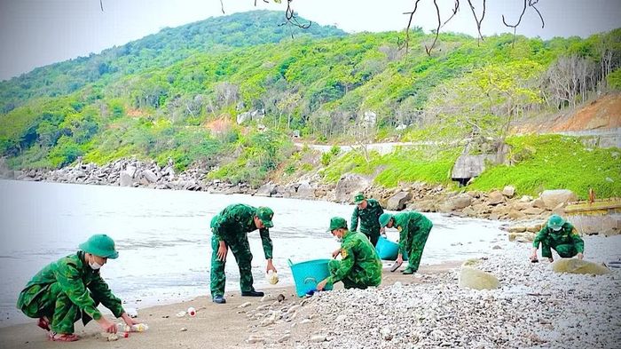 Cán bộ, chiến sĩ Đồn Biên phòng Hòn Khoai tham gia thu dọn chai nhựa, góp phần làm sạch rác vùng ven biển. (Ảnh: ĐÌNH THẮNG)