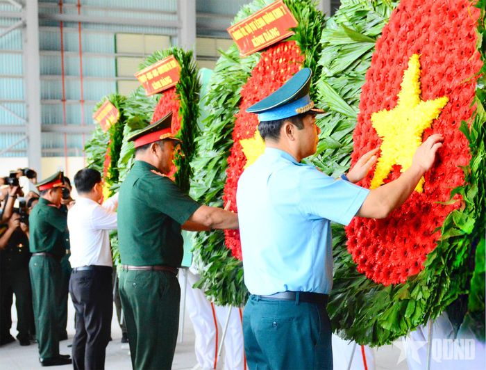  Các đại biểu chỉnh hoa trước khi dâng hương tưởng niệm các anh hùng liệt sĩ. 