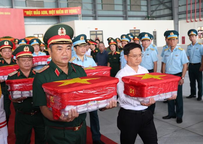 Trung tướng Lê Xuân Thế và Phó Chủ tịch UBND TPHCM Nguyễn Mạnh Cường (hàng đầu) thực hiện nghi thức chuyển các mẫu sinh phẩm lên máy bay quân sự đưa đi Hà Nội để thực hiện công tác giám định ADN.