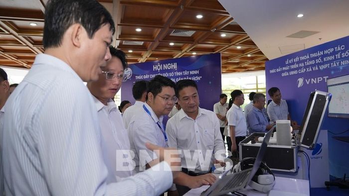 Lãnh đạo các xã, phường trên địa bàn tỉnh Tây Ninh tham quan, trải nghiệm các giải pháp công nghệ, nền tảng số được giới thiệu tại một sự kiện về khoa học, công nghệ và chuyển đổi số. Ảnh: Minh Phú - TTXVN