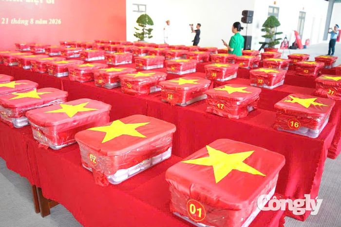 100 thùng mẫu hài cốt liệt sĩ được phủ Quốc kỳ trang nghiêm.
