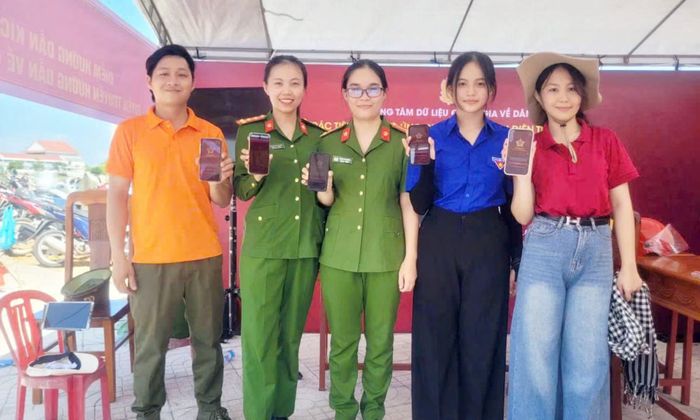 Cán bộ Công an xã Tam Anh hỗ trợ người dân cài đặt ứng dụng VNeID, thực hiện chuyển đổi số.