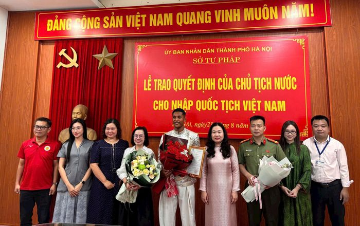 Cầu thủ Nguyễn Adou Leygley Minh chụp ảnh kỷ niệm cùng lãnh đạo Sở Tư pháp Hà Nội và người thân. Ảnh: PV