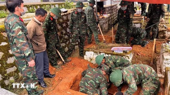 Các chiến sỹ đang tổ chức khai quật hài cốt liệt sỹ để đưa về Nghĩa trang Liệt sỹ Đà Lạt. (Ảnh TTXVN phát)