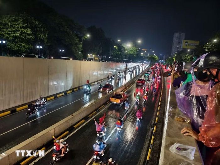 Cơn mưa xuyên suốt cả ngày không ngăn được niềm vui của người hâm mộ Thủ đô. (Ảnh: Minh Quyết/TTXVN)