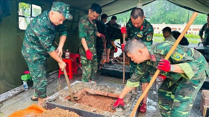 Lực lượng chức năng tiến hành khai quật các liệt sĩ chưa xác định danh tính. Ảnh: TTXVN phát