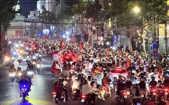 Đông đảo người hâm mộ bóng đá đổ về khu vực vòng xoay Đèn bốn ngọn, đường Trần Hưng Đạo (phường Long Xuyên, An Giang) ăn mừng chiến thắng của đội tuyển Việt Nam.