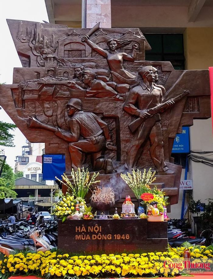 Mặt trước của tấm phù điêu có hình ảnh các chiến sĩ cảm tử quân ôm bom ba càng, đây là một hình ảnh mang tính biểu tượng cho sự kiện 60 ngày đêm bảo vệ Thủ đô. Cùng với đó có hình ảnh anh bộ đội cầm súng, công nhân, phụ nữ Thủ đô cùng sát cánh bên các chiến sĩ bảo vệ Hà Nội. Trên nền là những mái nhà của phố cổ lô xô, dáng hình chợ Đồng Xuân và ô Quan Chưởng xưa.