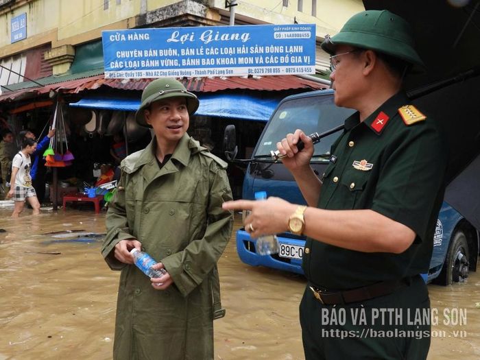 Đại tá Mai Xuân Phong, Ủy viên Ban Thường vụ Tỉnh ủy, Chỉ huy trưởng Bộ chỉ huy Quân sự tỉnh cùng với lãnh đạo Đảng ủy phường Kỳ Lừa chỉ huy hỗ trợ tiểu thương di chuyển hàng hóa ra khu vực an toàn