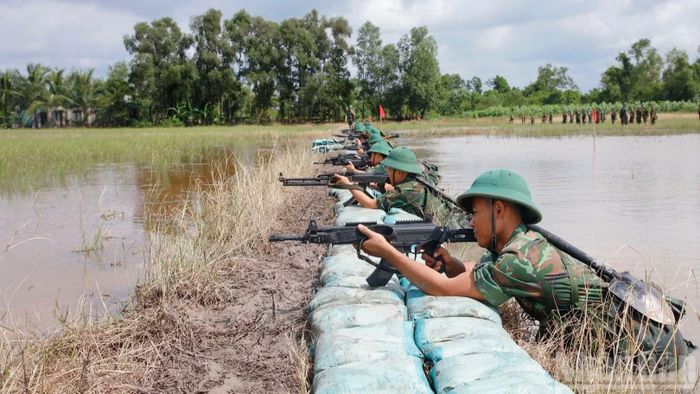 Học viên huấn luyện động tác bắn ở địa hình đồng bằng nhiều kênh rạch. (Ảnh: NGỌC DŨNG)