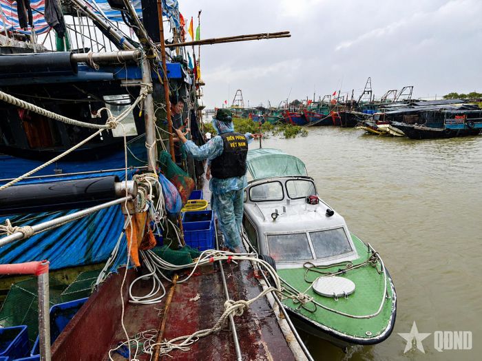  Cán bộ Đồn Biên phòng Trà Cổ, Ban chỉ huy Bộ đội Biên phòng tỉnh Quảng Ninh hướng dẫn ngư dân phòng, chống bão. Ảnh: XUÂN HÙNG