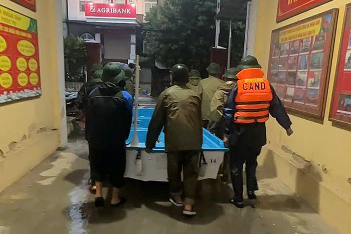 Nước dâng cao, có nơi ngập gần hết tầng 1, lực lượng chức năng căng mình hỗ trợ người dân tới nơi an toàn trong đêm. Ảnh: Đ.X