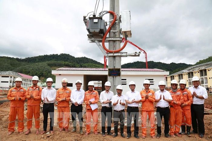 Ông Phan Hiền Trí, Phó Giám đốc Công ty Điện lực Đà Nẵng (thứ 6 bên phải sang) khen thưởng các đơn vị đã nỗ lực trong công tác cấp điện tại các điểm trường. Ảnh: TTXVN phát 