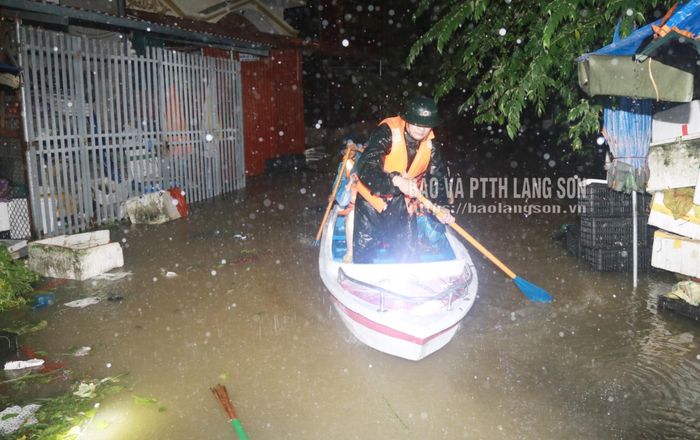Lực lượng chức năng đưa trường hợp phải cưỡng chế ra khỏi vùng ngập lụt để bảo đảm an toàn