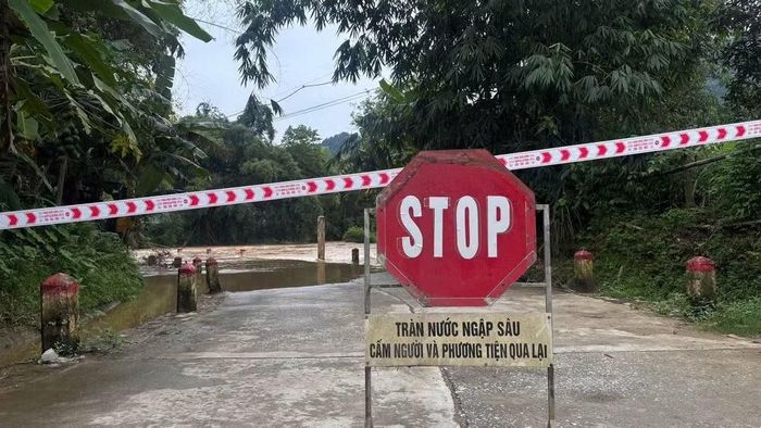 Một ngầm tràn tại xã Phúc Lộc bị ngập sâu được lực lượng chức năng cắm biển cảnh báo cấm lưu thông để bảo đảm an toàn. (Ảnh: NGỌC TÚ)